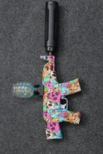 Graffiti AK47 Gel Blaster with colorful skull design, black suppressor, and grenade hopper next to its original box.