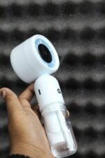 DP 7645 Turbo Mist Spray Handheld Fan showing its misting nozzle and ergonomic handle.