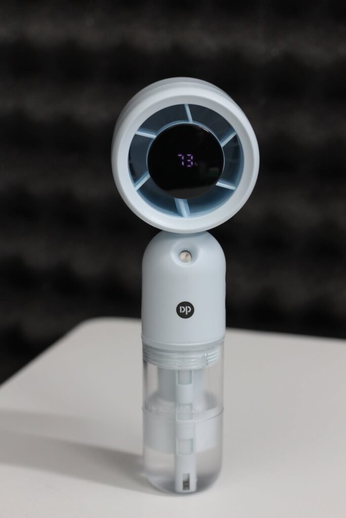 DP 7645 Turbo Mist Spray Handheld Fan showing its misting nozzle and ergonomic handle.
