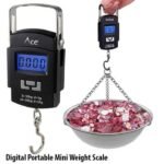 Electronic Portable Scale in black color showing the compact handheld ABS casing body, front premium digital backlit LCD display panel, controls button layout, and the bottom heavy duty stainless steel hanging hook configuration