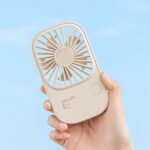 JISULIFE FA49 portable rechargeable handheld fan showing compact lightweight body handle multi speed control button quiet turbine cooling head 2000mah battery USB charging port front view lifestyle setup color choices