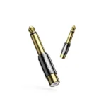 UGREEN 80731 audio adapter showcasing its gold-plated 6.35mm quarter-inch male mono plug end and an open RCA female socket connector on the opposite side with a textured brass grip barrel