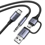 UGREEN 45009 CM772 2-in-1 audio adapter cable layout showing its USB Type-C male source connector split down into a 3.5mm male audio aux plug and dual USB-C plus USB-A charging interface inputs enclosed in space-gray aluminum shells with black braided jackets