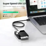 UGREEN 30333 USB 3 All-in-One Card Reader with 50cm Cable housing featuring individual SD Micro SD CF and MS card slots resting on a flat surface beside a notebook