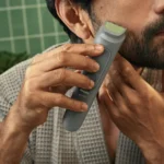 Philips MG3911/15 3000 Series 7-in-1 multi-grooming cordless trimmer handle displayed with nose trimmer head, stubble and beard combs, intimate area guard comb, and USB-A charging wire turn on