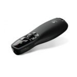 Logitech R400 wireless presenter showcasing its matte black contoured handheld casing tactile slide navigation buttons bright red laser pointer aperture light and green battery status LED indicator panel