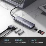 UGREEN 70411 USB-C Hub premium high capacity heavy duty 6-in-1 portable 4K HDMI fast charging laptop docking station block showing clean Space Gray aluminum minimalist housing body layout with side terminal input port slots and attached type-c cord wire view]