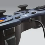 Logitech F310 wired gamepad controller showcasing its dark blue contoured shell body dual clickable analog thumbsticks floating directional D-pad color coded ABXY action buttons and low latency attached USB cable