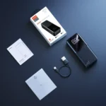 Joyroom JR-T015 Star Series 30000mAh 15W Power Bank in matte black standing upright to display its glossy top-half screen showing 100 percent battery capacity status next to its dual input and triple output ports