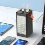 Hoco J107 Super 22.5W 90000mAh Fully Compatible Power Banks displayed in black and white retail boxes highlighting their massive front panel LED light boards, bright orange leather carry handles, top digital power meters, and extensive port configurations