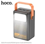 HOCO J110A 60000mAh Power Bank premium high capacity heavy duty 65W laptop portable power station brick retail box packaging layout in orange and white showing dark gray vertical body block with a large integrated rectangular white led lamp panel orange silicone carry handle strap and top multi-port array view]