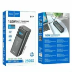 HOCO Q17 25000mAh Power Bank premium high capacity flagship 140W laptop fast charging portable power bank block retail packaging box layout showing sleek space gray brushed metal aluminum chassis body block with clear blue rectangular interactive tft color display reading output diagnostic variables and top dual usb-c layout view]