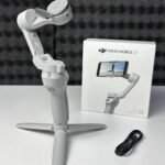 DJI Osmo Mobile SE Gimbal showing its foldable design and magnetic smartphone clamp.