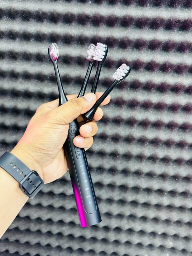 HOCO HP60 Electric Toothbrush showing its sleek waterproof body and interchangeable brush heads.